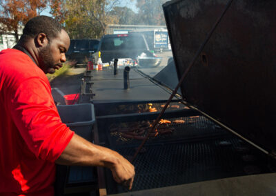 A South Carolina grill master grilling food on a charcoal grill.